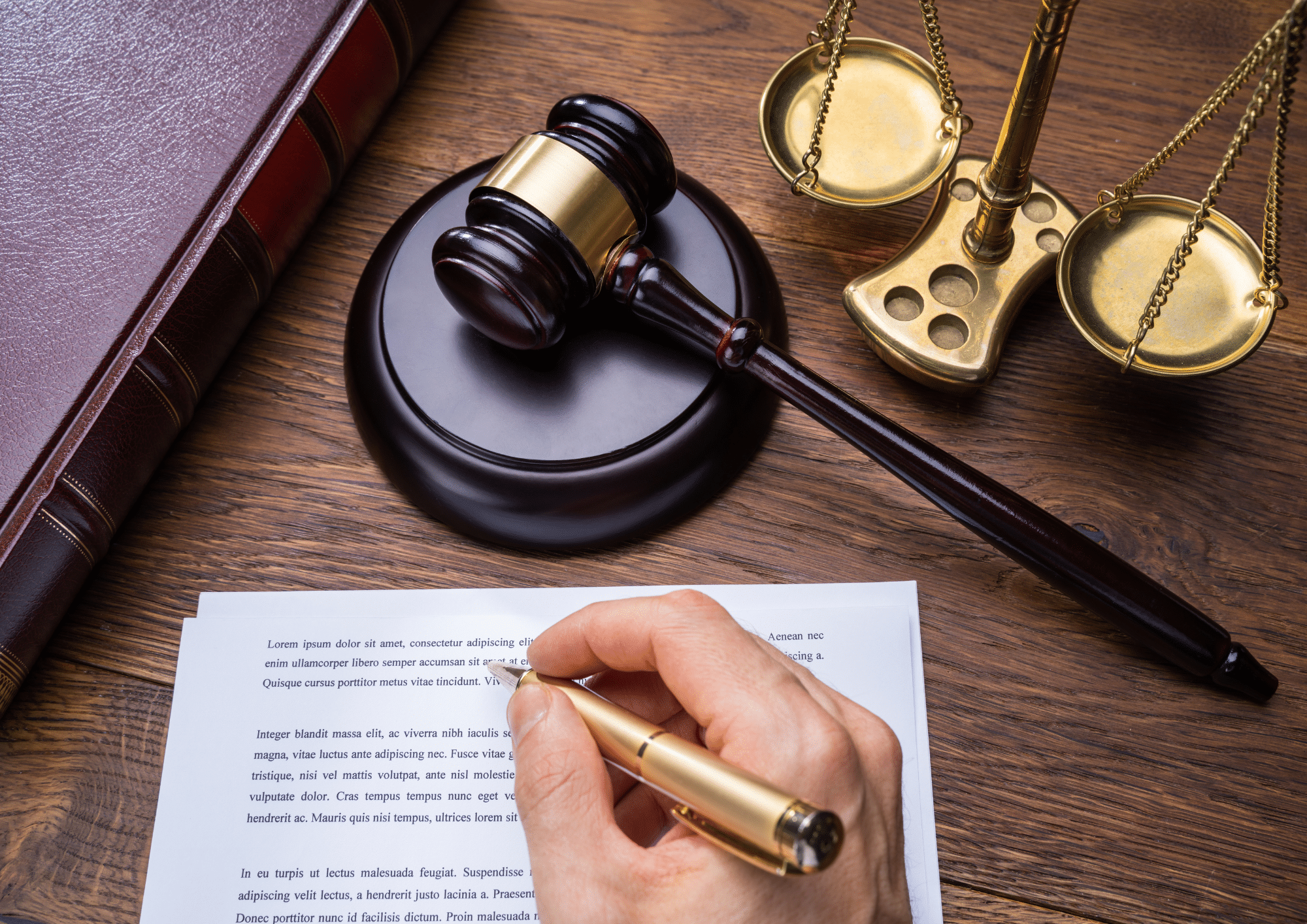 Legal professional preparing legal documents with judge’s gavel and scales of justice